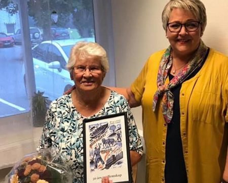 Ordfører Inger Løite kunne overrekke blomster og diplom til Asbjørg Skogli for lang og tro tjeneste i Arbeiderpartiet. Foto: Privat.